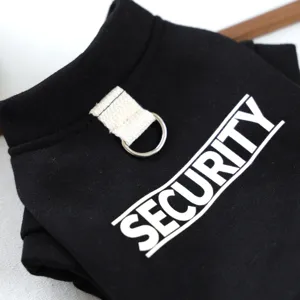 Detailed shot of black pet dog hoodie with security print and metal D-ring for leash.