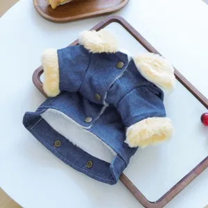 Detailed close-up of pet denim winter coat featuring warm fleece lining and metal snap buttons.