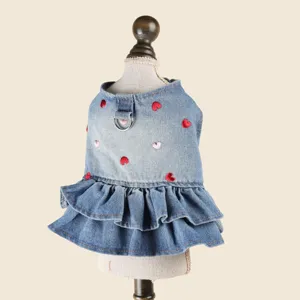 Detailed shot of pet denim dress, featuring cute embroidered red hearts and double ruffles.