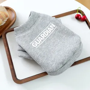 Gray pet hoodie detail showing soft knit fabric and Guardian letter print on neat display tray.