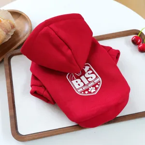 Red pet hoodie with hooded design and white letter print, neatly folded for small dogs.