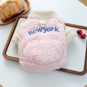 Detailed shot of cute pink and white pet fleece vest with cozy lamb wool texture and D-ring.