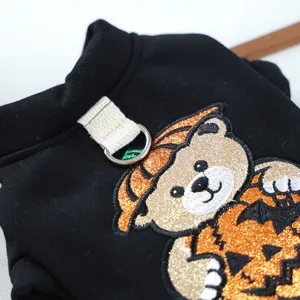 Detailed view of black pet halloween hoodie featuring cute embroidered bear and pumpkin.