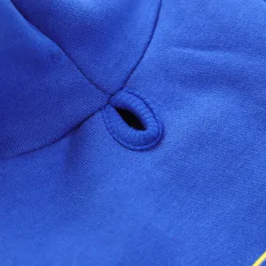 Blue pet hoodie detail shot showing fine stitching and drawstring eyelet for small dogs.