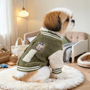Cozy green sherpa fleece pet baseball jacket detail with cute bear patch and ribbed collar.