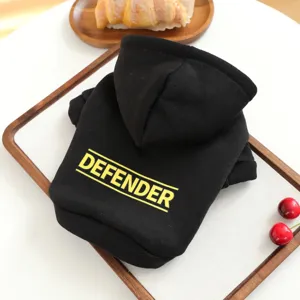 Detailed view of black pet hooded sweatshirt with yellow letter print on the back.