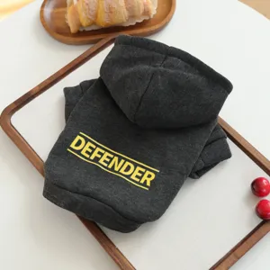 Dark grey pet hoodie detail featuring yellow defender print, soft fabric for small dogs.