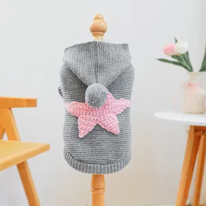 Cute grey pet knitted sweater for small dogs with pink star, pom-pom hood, and cozy Nordic design.