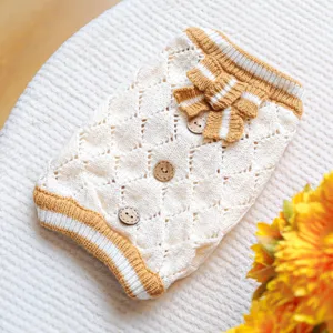 Cozy knit dog sweater with hollow-out diamond pattern, wooden buttons, and cute bow detail.