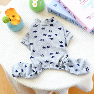 Detailed view of gray pet onesie with blue stars pattern, soft fabric for small dogs.