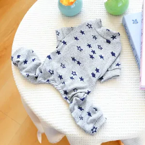 Detail view of a grey pet onesie with blue stars, cute loungewear for small dogs and puppies.