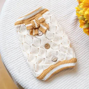 Detailed view of cream knitted pet sweater with cute bow and wooden buttons for small dogs.
