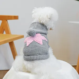 Close-up detail of the grey knit pet sweater with a cute pink star motif and comfortable hood.