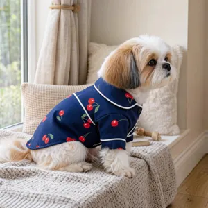 Cute cherry print pet pajama detail shot, showing soft navy blue fabric and white piping design.