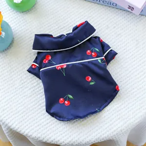 Cherry pet pajamas detail, dark blue fabric with red cherry print and white piping for dogs cats.