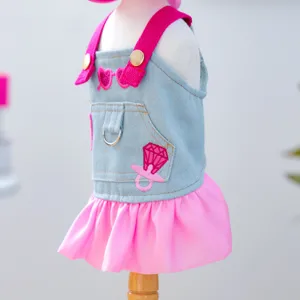 Cute pet denim dress with pink ruffles and hat set, stylish puppy cat apparel detail view.