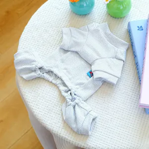 Close-up detail of soft black and white striped pet jumpsuit for small dogs home wear.