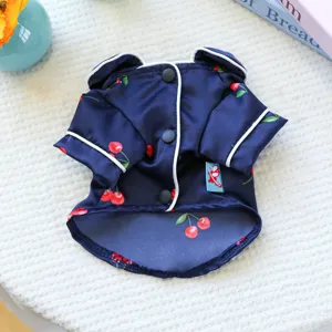 Detail view of cute navy blue pet pajamas featuring a sweet red cherry print and white piping.