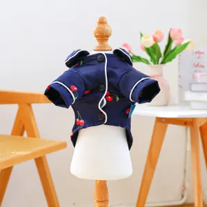 Detailed view of the cute navy blue pet pajama with red cherry print and white piping.
