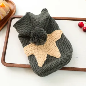 Detailed view of a dark grey knit pet sweater with cute star motif, pom-pom, and cozy texture.