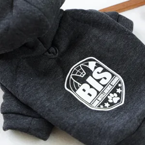 Close up detail of dark grey pet dog hoodie with white shield logo and letter print texture.