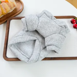 Grey pet hoodie detail shot showing soft fabric and neat folding on a wooden tray.