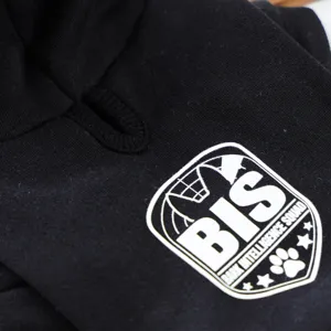 Detail shot of black pet dog hoodie featuring a white BIS bark intelligence squad print badge.