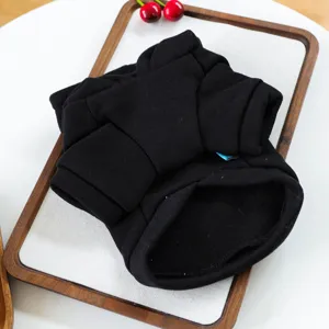 Close-up detail of soft black pet hoodie apparel, neat folding presentation for small dogs cats.