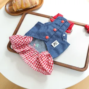 Close-up detail of the cute denim pet dress with red gingham ruffles and cherry embroidery.