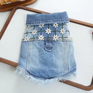 Detailed close-up of a stylish pet denim jacket for small dogs with daisy embroidery and leash ring.
