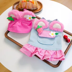 Cute pet clothing detail view, featuring a pink plush ear hat and sweet denim floral dress.
