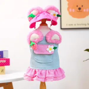 Cute pink pet dog cat denim dress and fluffy strawberry hat set detail, stylish pet apparel.