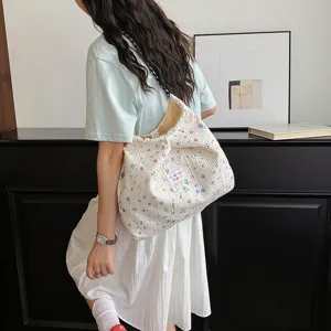 Floral puckered shoulder bag detail, stylish canvas tote bag with drawstring closure, casual daily use.