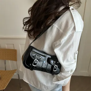 Black patent leather shoulder bag, chic underarm baguette handbag with dual front pockets.