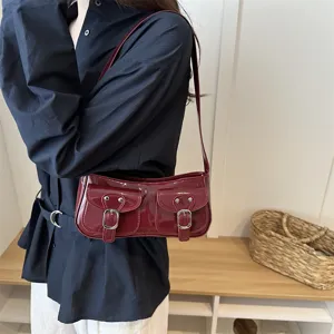 Dark red patent leather shoulder bag, chic baguette bag with double flap pockets and buckles.
