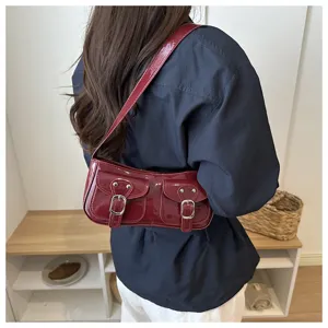 Trendy patent leather baguette shoulder bag, cool motorcycle style chic commuter handbag.