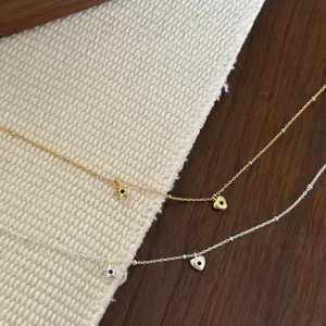 Délicats colliers étoile et cœur en argent et or avec chic zircons noirs pour femmes.