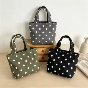 Polka dot canvas mini tote bag, durable handbag showcasing detailed print and compact design.