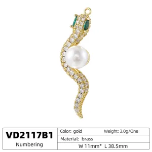 Gold snake pendant detail shot featuring sparkling cubic zirconia and a central white pearl.