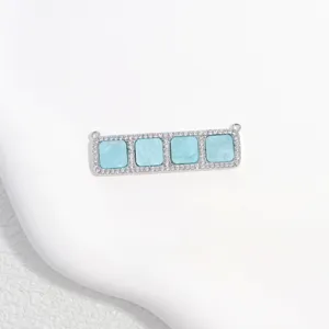 Close-up of rectangular copper zircon four-square connector charm for DIY jewelry making.