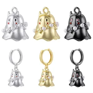 Close-up of cute ghost pearl pendants and earrings in silver, gold, and black colors.