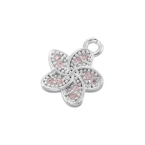 Close up of copper inlaid pink cubic zirconia five petal flower pendant charm detail view.