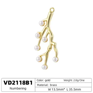Detail shot of golden brass coral branch pendant with white pearls, size 13.5x35.5mm.