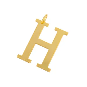 Golden metal letter H charm pendant, detailed close-up shot of alphabet jewelry accessory.