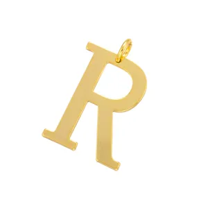 Close-up of a gold-colored metal letter R pendant accessory, detailed view for DIY jewelry.