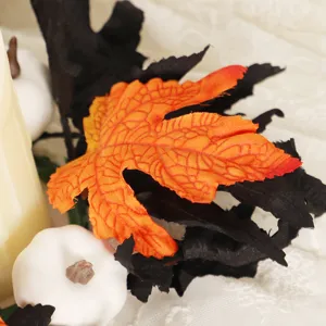 Halloween candle ring decoration with artificial maple leaves and white pumpkins for party decor.