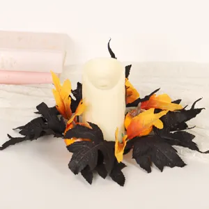 Halloween party decorative candle ring with black and orange maple leaves and small pumpkins.