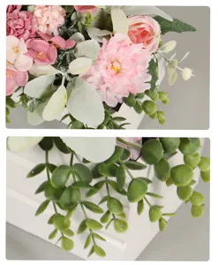 Nahaufnahme Detailansicht von künstlichem rosa Rosenblumenstrauß und grüner Rankendekoration.