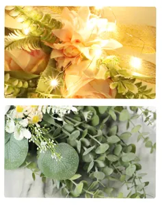 Künstliche Dahlien- und Rosen-Wanddekoration Detail mit Eukalyptusblättern und warmer Lichterkette.