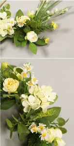 Gros plan détaillé d'une couronne de fleurs artificielles de printemps avec roses et feuillage.